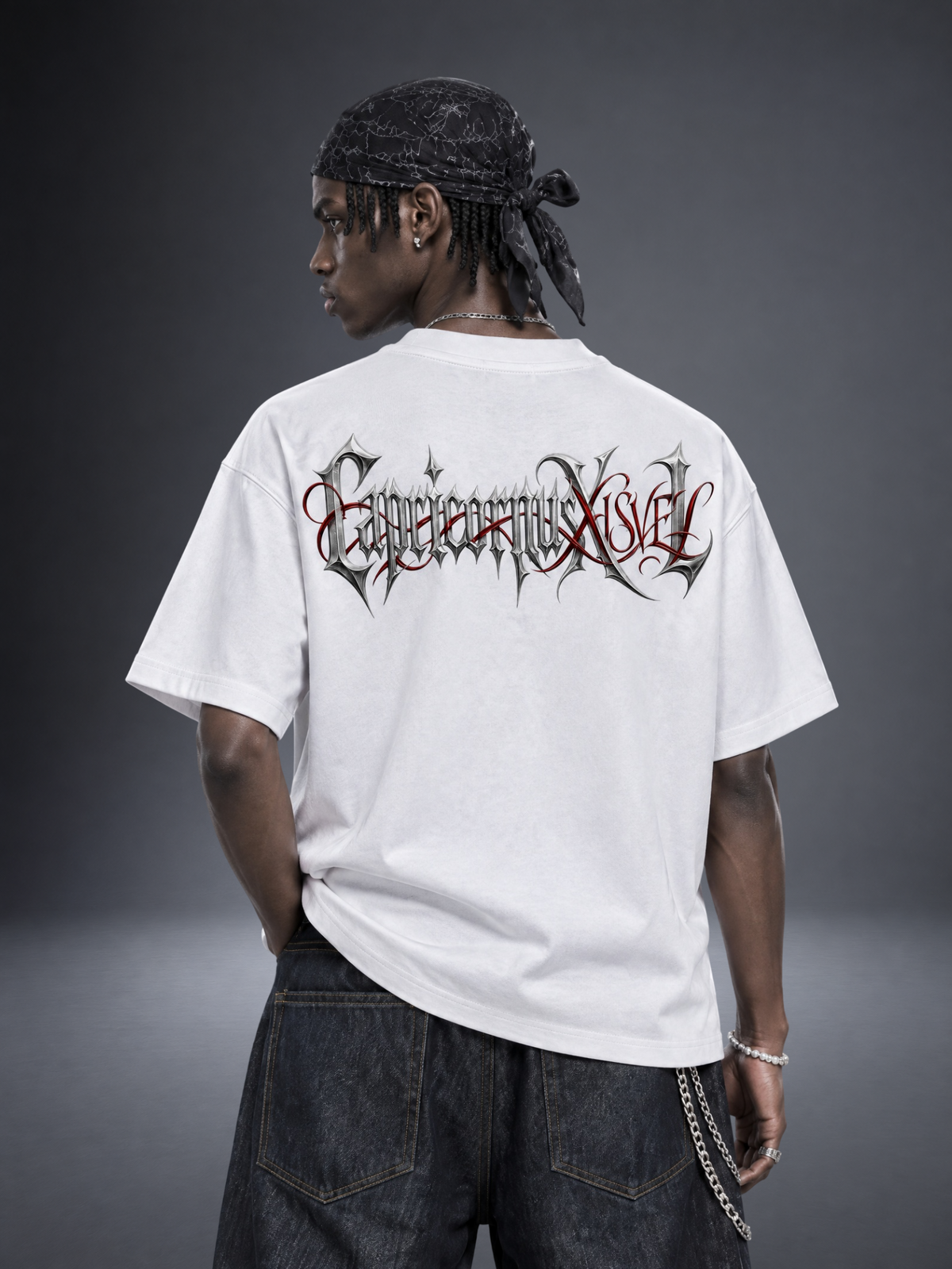 Capricorn zodiac white graphic tee - gothic 'Capricornus' lettering with red XISVEL script across the back
