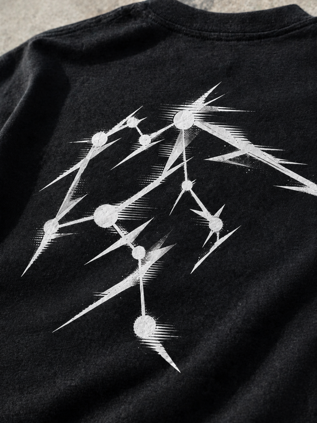 Close-up of the white Aquarius constellation back print on black cotton fabric